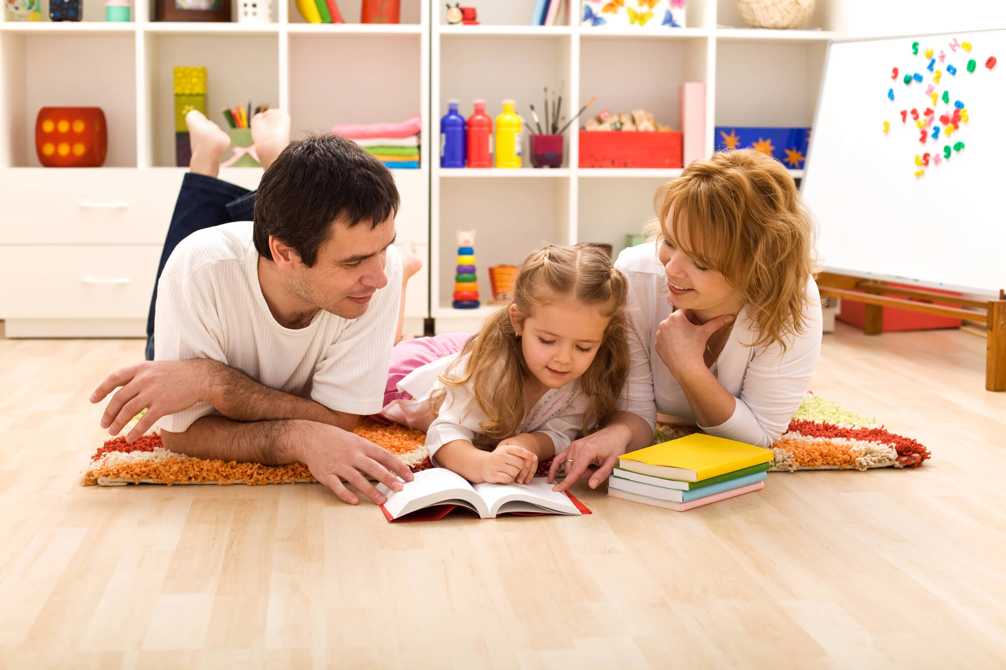 girl reading with parents after going to a k-12 learning center