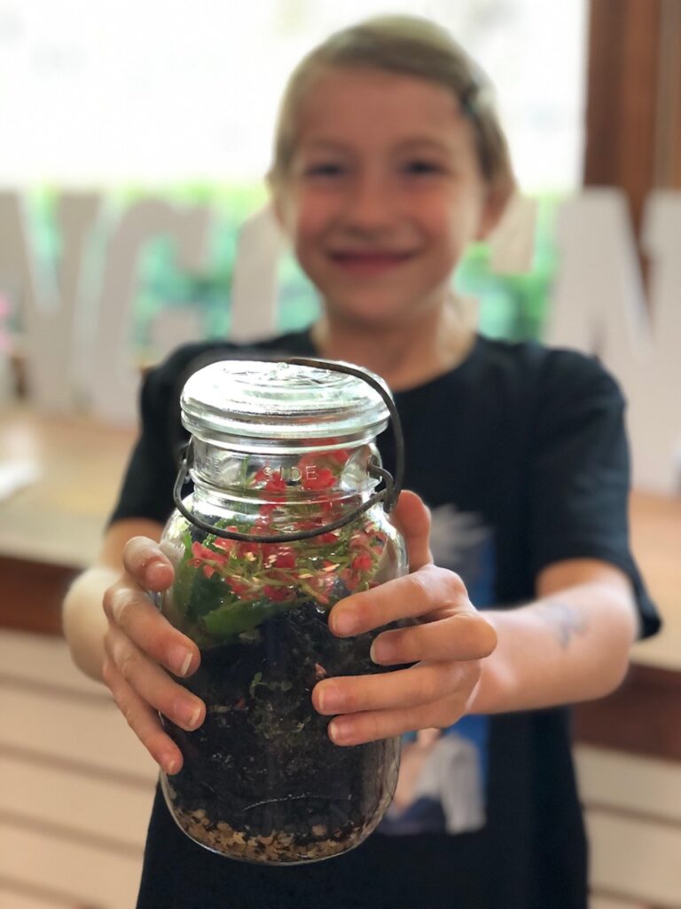 child showing a terrarium done at a birthday party in Woodbury Ct