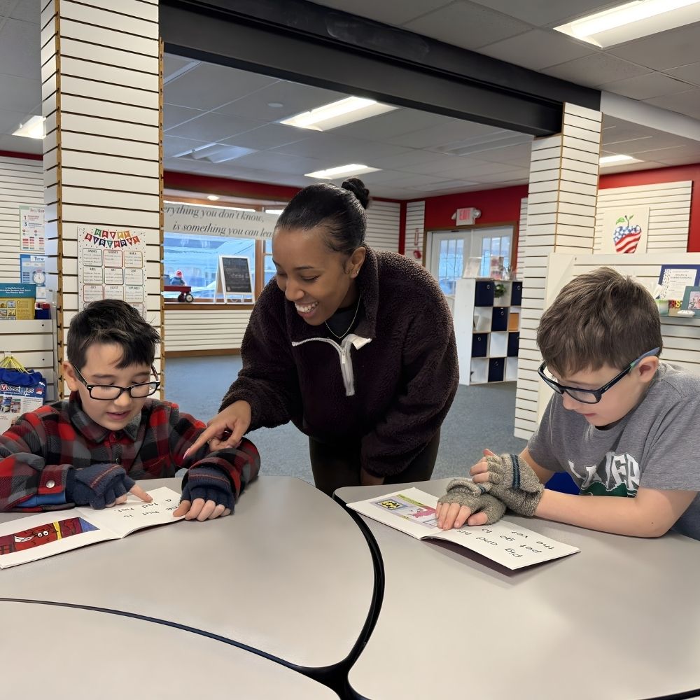 Children learning with a smiling tutor in Woodbury, CT